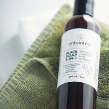Load image into Gallery viewer, Natural Multi-Purpose Black Soap Cleanser - FrontSide - placed down on a towel inside spa