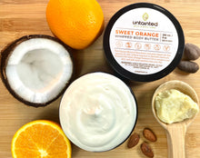 Load image into Gallery viewer, Scented Sweet Orange Whipped Body Butter – Front of Lid, opened container showing whipped body butter, orange, cocoa chunks, shea butter, almonds.