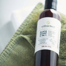 Load image into Gallery viewer, Natural Multi-Purpose Black Soap Cleanser - FrontSide - placed down on a towel inside spa
