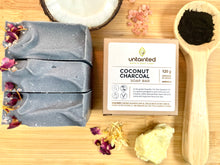 Load image into Gallery viewer, Scented Charcoal Soap Bar - Front Side of 120 g box with 3 120 g bars outside the box - charcoal powder and coconu tand shea butter
