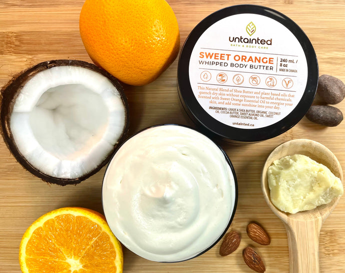 Scented Sweet Orange Whipped Body Butter – Front of Lid, opened container showing whipped body butter, orange, cocoa chunks, shea butter, almonds.